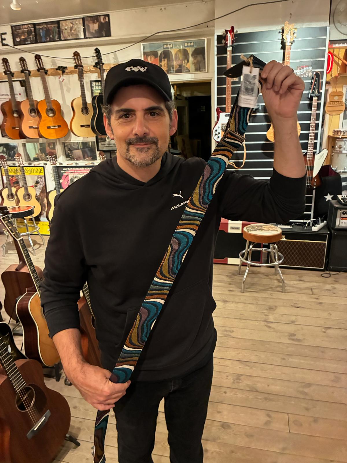 Country music star Brad Paisley holding up 'I Am The Walrus' strap